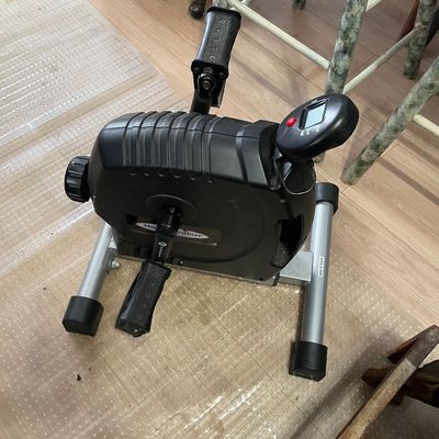 Sale Photo Thumbnail #11: MagneTrainer compact under-desk exercise pedaler with a digital display screen and adjustable tension knob.