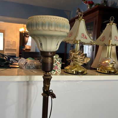 Sale Photo Thumbnail #30: Vintage floor lamp featuring an embossed glass shade with subtle blue and floral accents, shown alongside brass table lamps.