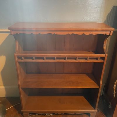 Sale Photo Thumbnail #5: Vintage Colonial revival style wooden bookcase featuring scalloped top trim and spindle accents on the upper shelf rail.