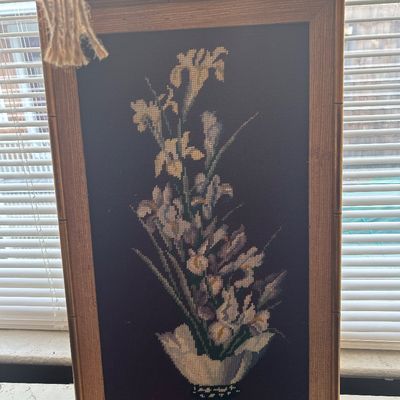 Sale Photo Thumbnail #74: Framed needlepoint floral artwork depicting irises in a vase on a dark background, set in a vintage faux-bamboo frame.