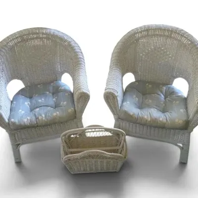 White wicker patio chairs with blue floral cushions magazine basket