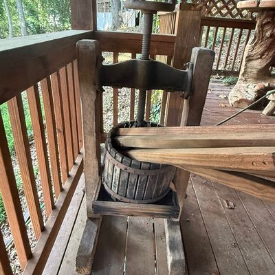 Sale Photo Thumbnail #230: Antique wooden and cast iron fruit press with a wooden slatted basket and threaded screw mechanism.