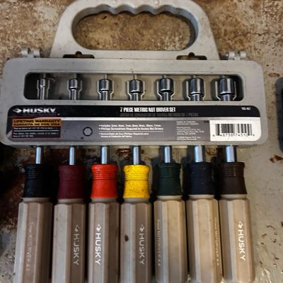Sale Photo Thumbnail #149: Husky 7-piece metric nut driver set with color-coded handles in its original plastic carrying case.