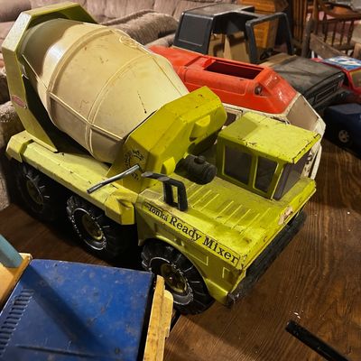 Sale Photo Thumbnail #130: Vintage chartreuse Tonka Ready Mixer toy truck, showing play wear consistent with age, alongside other assorted vintage toy vehicles.
