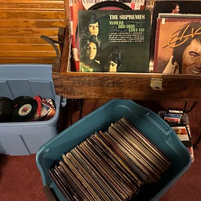 Sale Photo Thumbnail #186: Collection of vintage vinyl LP records and 45s displayed in plastic storage totes and a wooden crate, including albums by The Supremes and Elvis Presley.