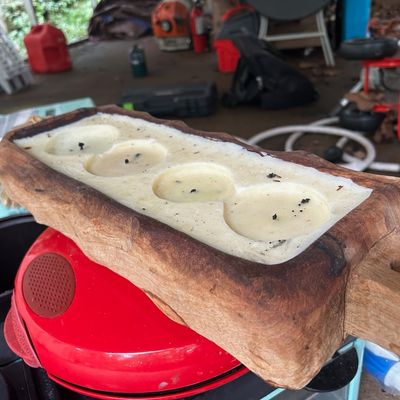 Sale Photo Thumbnail #142: Rustic carved wood dough bowl candle featuring four wicks and off-white wax.