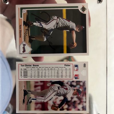 Sale Photo Thumbnail #61: 1991 Upper Deck Tom Glavine signed baseball card, hand-numbered 823/1000, shown alongside a second Glavine card inside a clear screw-down acrylic holder.