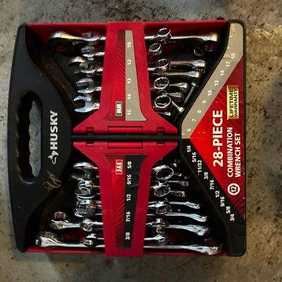 Sale Photo Thumbnail #154: Husky 28-piece combination wrench set housed in its original red and black plastic carrying rack, including both SAE and metric sizes.