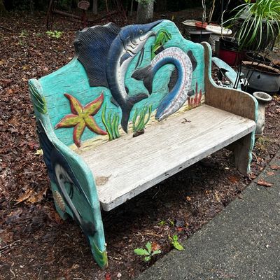 Sale Photo Thumbnail #121: Hand-carved and painted wooden garden bench featuring nautical reliefs of a sailfish, salmon, and starfish.