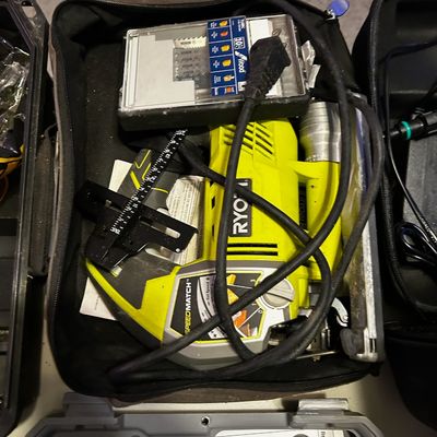Sale Photo Thumbnail #31: Ryobi SpeedMatch corded orbital jig saw packed in a zippered soft case alongside a Bosch saw blade set and edge guide.