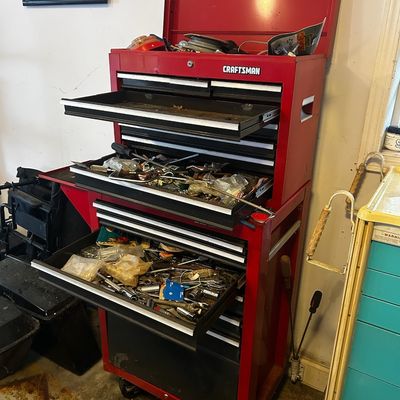 Sale Photo Thumbnail #56: Red Craftsman two-piece rolling tool chest combo filled with various hand tools and hardware.