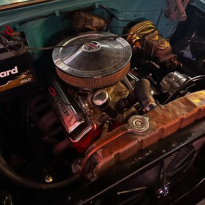 Sale Photo Thumbnail #66: Vintage Chevrolet V8 engine bay featuring a chrome air cleaner, red valve covers, and power brakes.