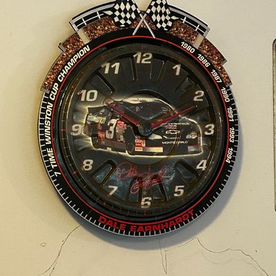 Sale Photo Thumbnail #146: Dale Earnhardt 7-Time Winston Cup Champion commemorative wall clock, featuring crossed checkered flags and his #3 Chevy Monte Carlo.