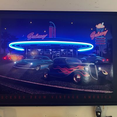 Sale Photo Thumbnail #89: Framed illuminated artwork titled "Scenes From Vintage America," depicting classic hot rods parked outside a retro neon-lit diner.