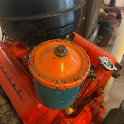 Sale Photo Thumbnail #49: Vintage Chevrolet V8 engine block featuring a vintage orange and blue AC Type S-6 oil filter canister and black air cleaner.