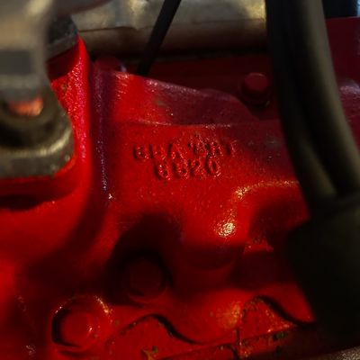 Sale Photo Thumbnail #55: Close-up of a red engine block showing cast serial and part numbers.