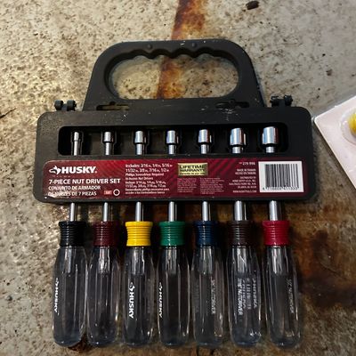 Sale Photo Thumbnail #151: Husky 7-piece SAE nut driver set with color-coded handles in a black plastic storage rack.