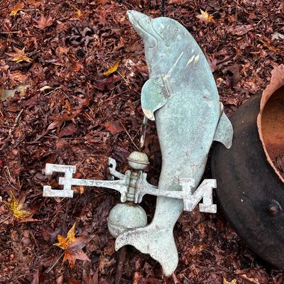Sale Photo Thumbnail #120: Vintage weathered copper dolphin weather vane with directionals and globe, displaying a natural verdigris patina.