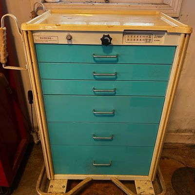 Sale Photo Thumbnail #57: Vintage Armstrong Medical crash cart with teal drawers, push handle, and digital keypad lock on a wheeled base.