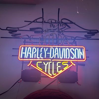 Sale Photo Thumbnail #99: Illuminated Harley-Davidson Motor Cycles neon bar sign with eagle wings graphic mounted on a metal frame.