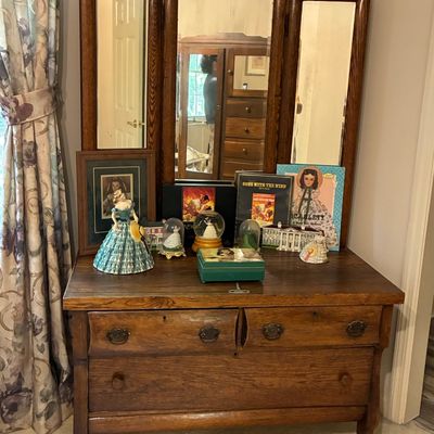 Sale Photo Thumbnail #214: Antique oak tri-fold mirror vanity dresser, displaying various Gone with the Wind collectibles, figurines, and books.