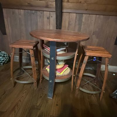 Sale Photo Thumbnail #248: Rustic three-piece pub table and stool set constructed from reclaimed wood and wine barrel staves.