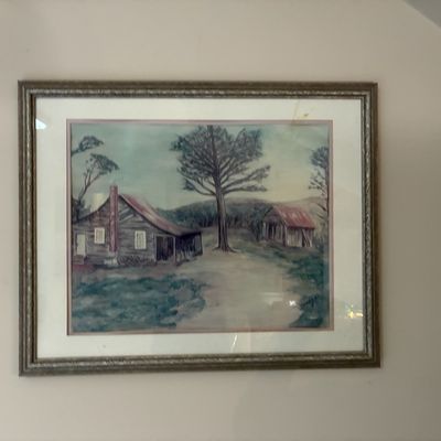 Sale Photo Thumbnail #190: Framed landscape painting depicting a rural homestead and barn, presented in a matted metallic frame.