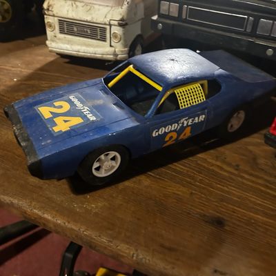 Sale Photo Thumbnail #125: Vintage pressed steel blue Goodyear #24 stock car toy truck, showing moderate play wear.