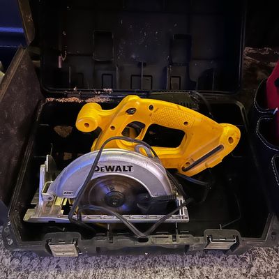 Sale Photo Thumbnail #26: DeWalt cordless circular saw stored inside a black hard shell carrying case.