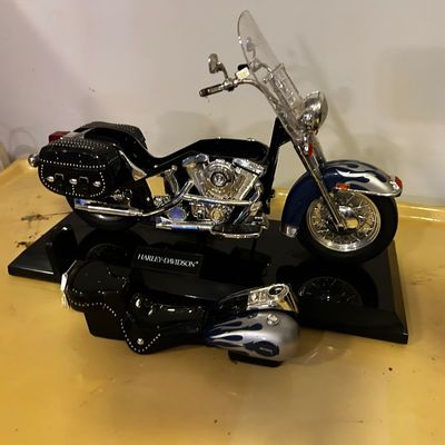 Sale Photo Thumbnail #17: Harley-Davidson scale model motorcycle display with flame graphics, chrome accents, and detachable body parts on a black base.