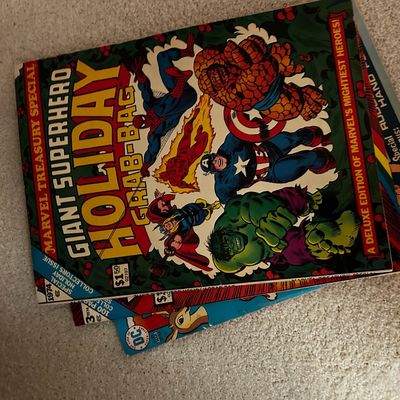 Sale Photo Thumbnail #140: Vintage 1974 Marvel Treasury Special Giant Superhero Holiday Grab-Bag comic book layered over other vintage comic books.