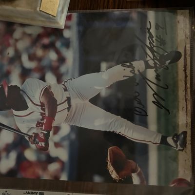 Sale Photo Thumbnail #63: Autographed color photograph of Atlanta Braves player David Justice, stored in a protective plastic sleeve.