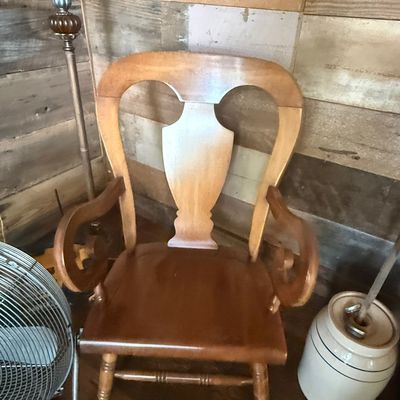 Sale Photo Thumbnail #244: Vintage light-toned wooden rocking chair featuring a urn-shaped splat back, scroll armrests, and turned legs.