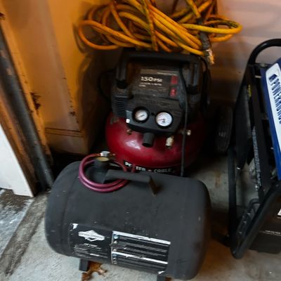 Sale Photo Thumbnail #8: Porter-Cable 150 PSI pancake air compressor with attached yellow air hose, accompanied by an auxiliary air tank.