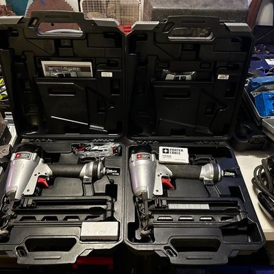 Sale Photo Thumbnail #35: Pair of Porter-Cable pneumatic finish nailers, each stored in its original black hard plastic carrying case.