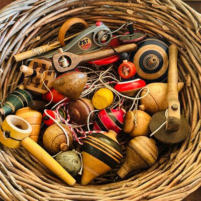 Sale Photo Thumbnail #48: Collection of vintage wooden spinning tops and string-pull tops.