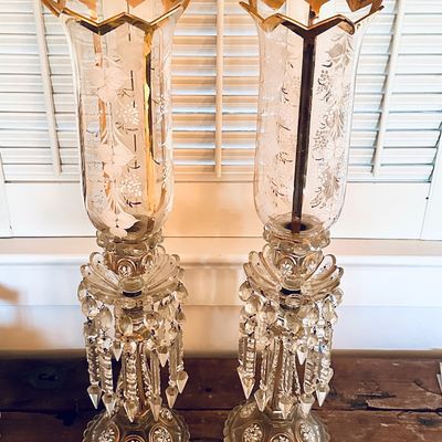 Sale Photo Thumbnail #52: Pair of Victorian-style Bohemian crystal luster candle holders featuring gold-rimmed scalloped tops, etched floral hurricane shades, and hanging crystal prisms.