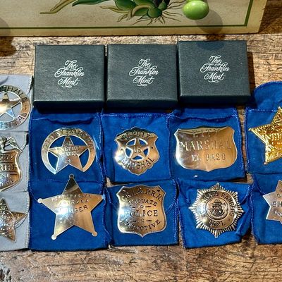 Sale Photo Thumbnail #99: Collection of ten replica Old West law enforcement badges from The Franklin Mint, 