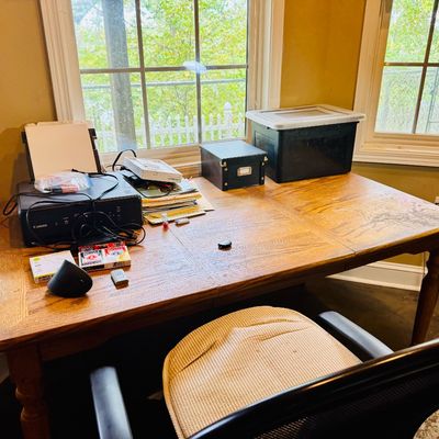 Sale Photo Thumbnail #58: Large oak dining or office table with turned legs, featuring a mesh desk chair, Canon printer, storage bins, and office supplies.