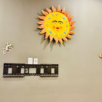 Sale Photo Thumbnail #35: Collection of vibrant Mexican folk art wall decor, including a large painted sun face with mirror accents, metal geckos, and tropical fish.