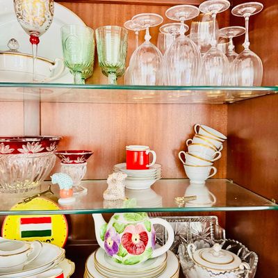 Sale Photo Thumbnail #77: Collection of vintage glassware and china displayed inside a wooden hutch, including ruby flash cut glass, crystal stemware, green depression glass, and gold-rimmed tea sets.