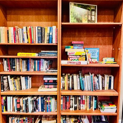 Sale Photo Thumbnail #40: Pair of tall, matching wooden bookcases filled with an assortment of books and board games.