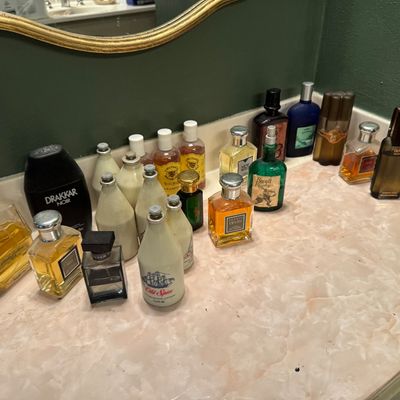 Sale Photo Thumbnail #66: Collection of vintage men's colognes and aftershaves arranged on a vanity counter, including Drakkar Noir, Old Spice, Devin, and Royall Rugby.