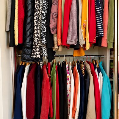 Sale Photo Thumbnail #61: Closet filled with women's colorful vintage and modern jackets, blazers, and coats neatly hanging on upper and lower clothing racks.