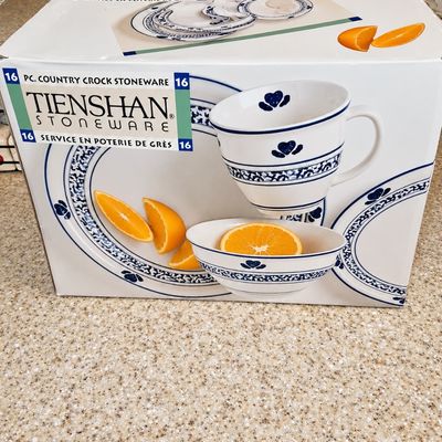 Sale Photo Thumbnail #88: Boxed 16-piece Tienshan Country Crock stoneware set featuring a blue sponge-style pattern with heart motifs.