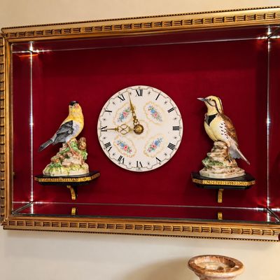 Sale Photo Thumbnail #80: Vintage framed shadowbox wall clock with red velvet backing and porcelain bird figurines mounted on small interior shelves.