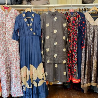 Sale Photo Thumbnail #67: Collection of South Asian formal wear, including embroidered dresses, kurtas, and salwar kameez sets in various colors hanging in a closet.