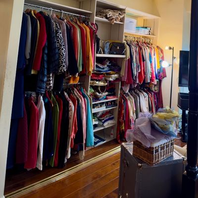 Sale Photo Thumbnail #84: Walk-in closet organized with a large collection of women's clothing, jackets, dresses, handbags, and accessories.