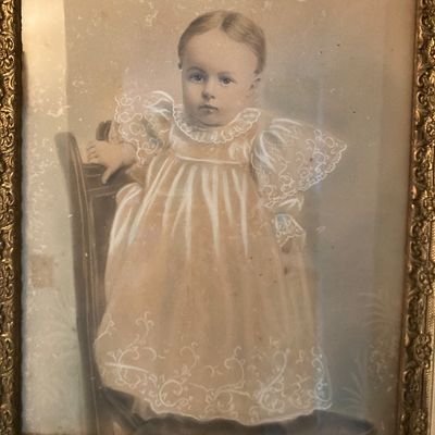 Sale Photo Thumbnail #220: Antique hand-colored portrait of a child in a lace gown, housed in an ornate gilded frame.