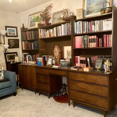 Mid-century modern three-piece wooden wall unit featuring bookshelves, a desk kneehole, drawers, and lower cabinets.